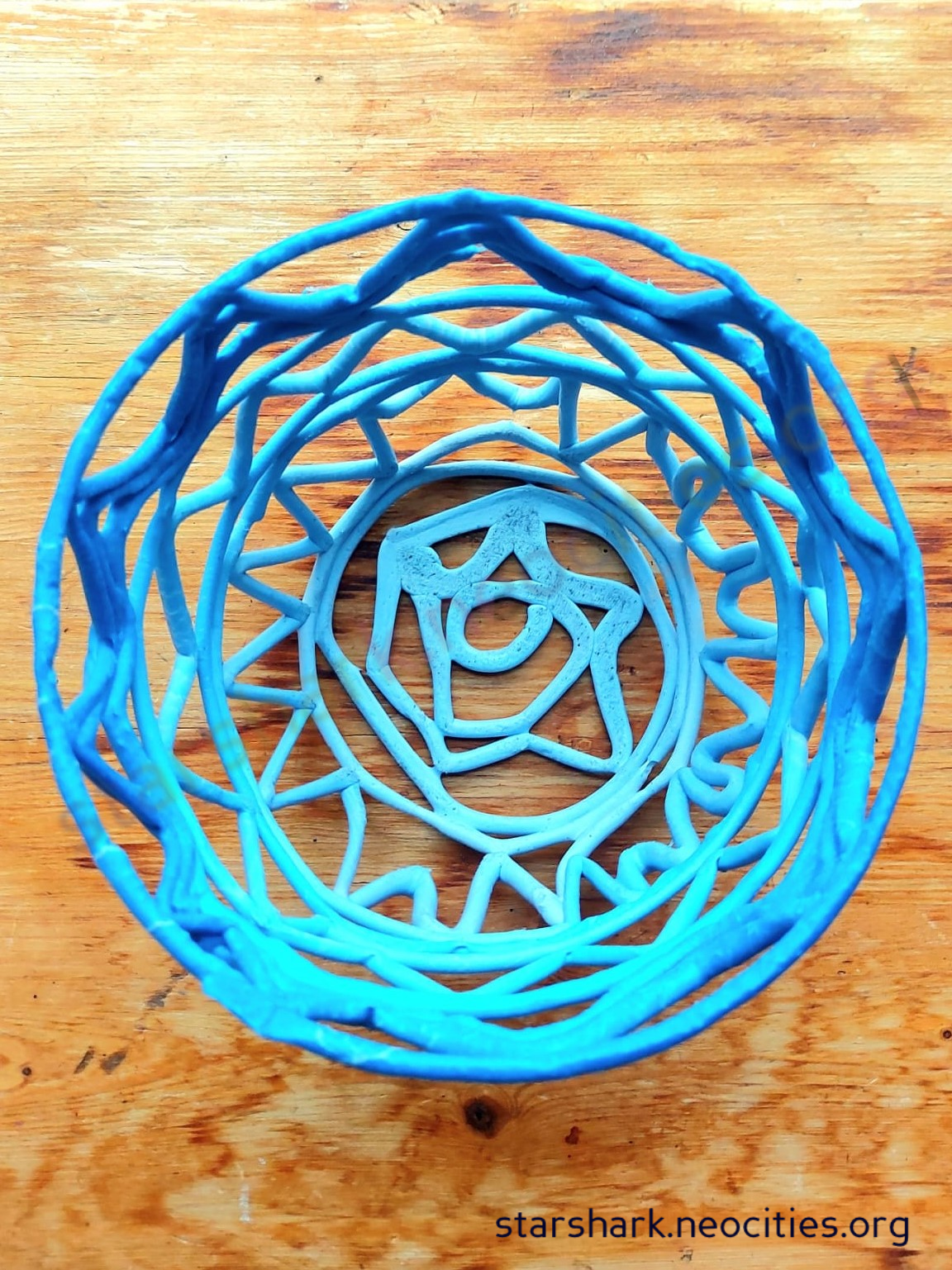 a top-view of a blue plant pot made by the plastic pottery technique